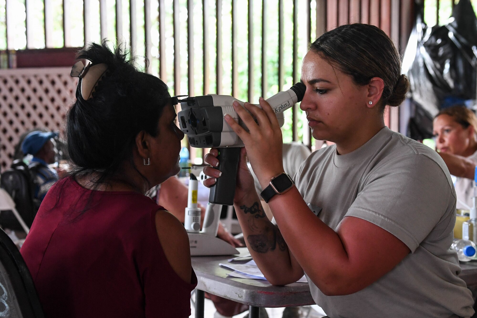 An optometry technician performs an eye exam.