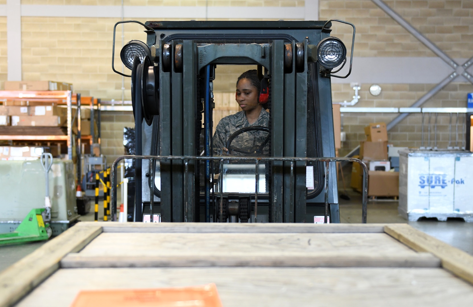 A 48th Deployment and Distribution Flight Airman operates a fork lift at Royal Air Force Lakenheath, England, April 15, 2019.  The flight provides Airmen with all necessary equipment to expediently deploy forward ready ensuring they can execute their mission. (U.S. Air Force photo by Staff Sgt. Alex Echols)