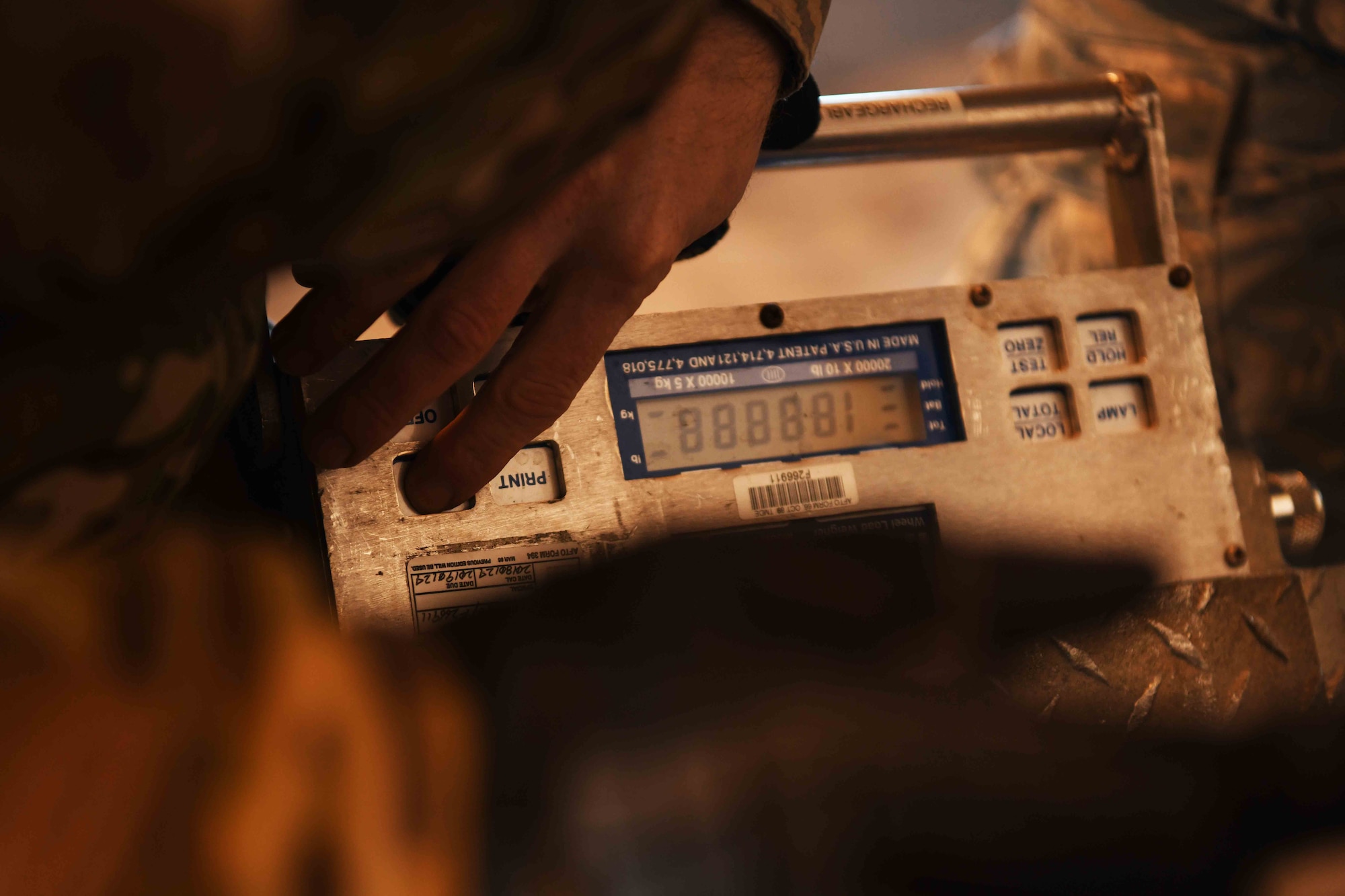 A 48th Deployment and Distribution Flight Airman checks a cargo scale used to weigh equipment at Royal Air Force Lakenheath, England, January 16, 2019. 48th LRS D-Flight is responsible for the planning and execution of all wing deployment operations and transportation of cargo and base personnel. (U.S. Air Force photo by Airman 1st Class Shanice Williams-Jones)