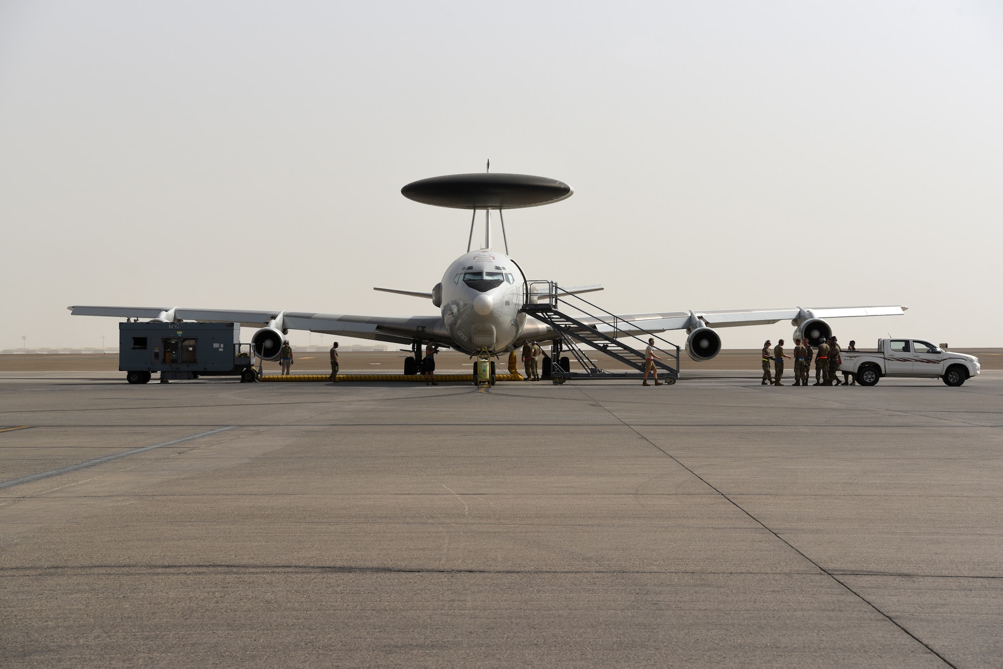 Crew chiefs assigned to the 380th Expeditionary Aircraft Maintenance Squadron remain with their E-3 Sentry Airborne Warning and Control System aircraft until it taxis for takeoff on Al Dhafra Air Base, United Arab Emirates, June 26, 2019.