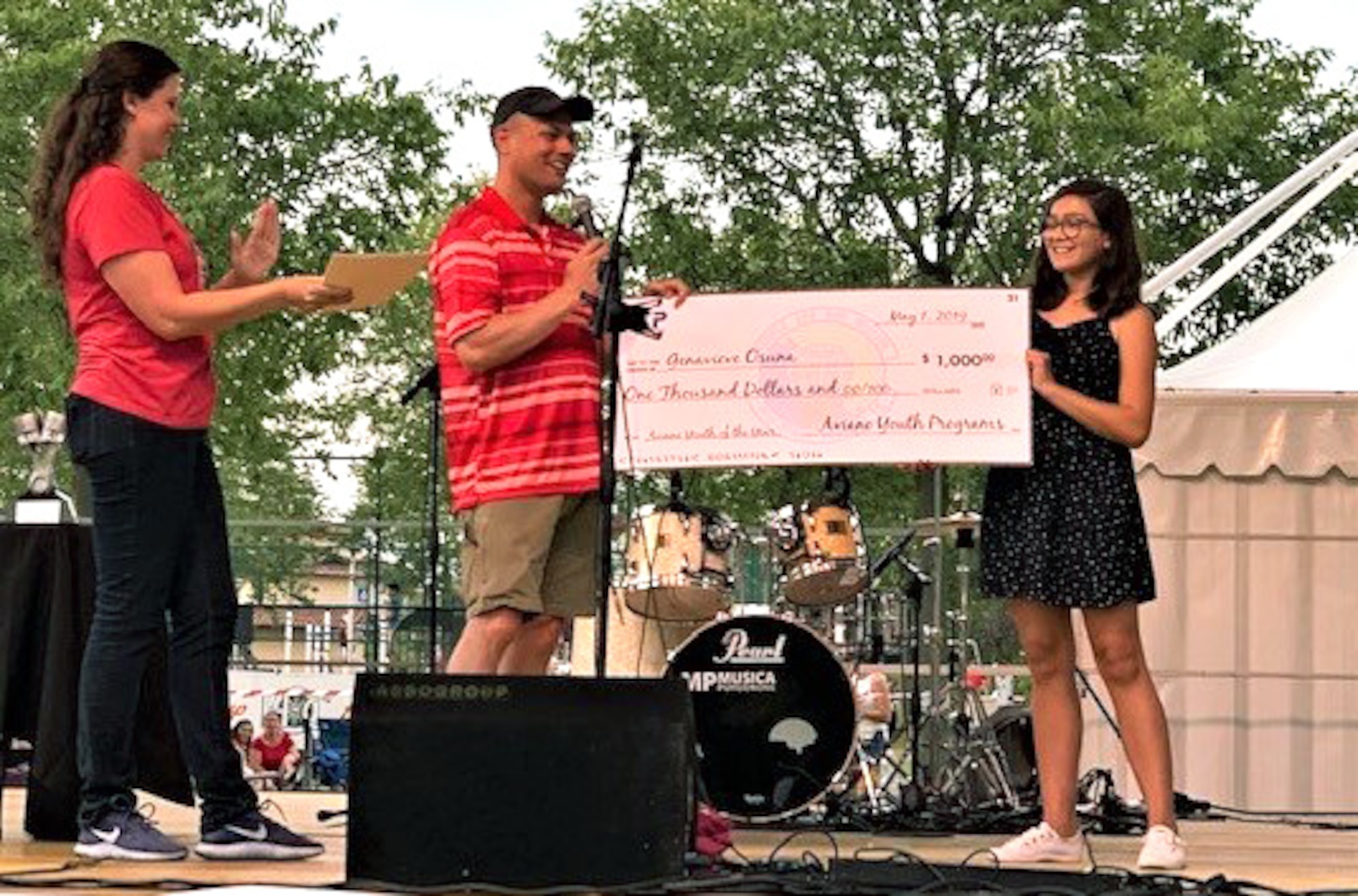 Genavieve Osuna, dependent of Senior Master Sgt. Jesus Osuna, from the 31st Logistics Readiness Squadron and Sinead Osuna, contractor for the 31st Medical Group receives a scholarship July 3, 2019, at Aviano Air Base, Italy. The Aviano Teen Center, located on Area 1 in the Community Center, offers a fun and safe environment for teens ages 13-18 under the supervision of trained program assistants. (Courtesy Photo)