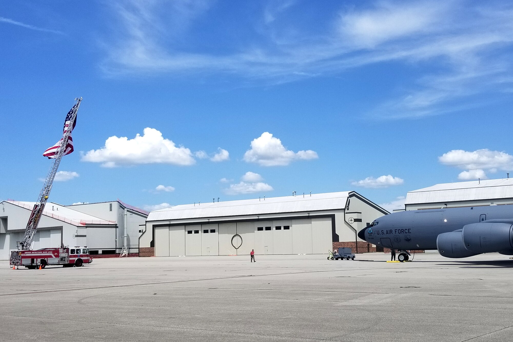 A Grissom fire truck supporting the U.S. flag greets a KC-135 Stratotanker at Grissom Air Reserve Base, Indiana, July 15, 2019.  The tanker transported 16 Airmen following their deployments from Baltimore-Washington International Airport back to Grissom were deployers were greeted by friends and family. (U.S. Air Force photo/Ben Mota)