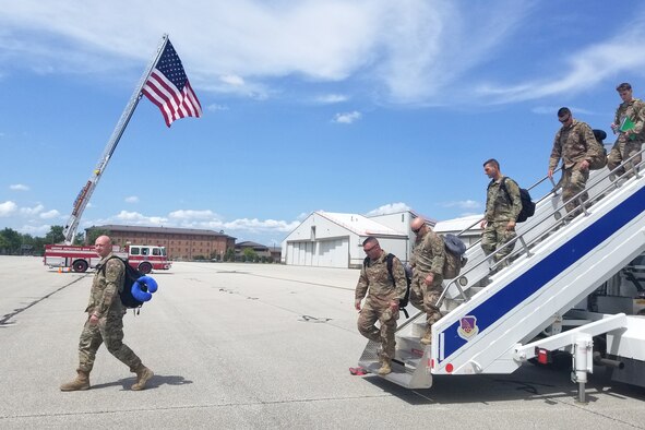 The Grissom Fire Department flies a U.S. flag for returning Airmen exiting their aircraft at Grissom Air Reserve Base, Indiana July 15, 2019. Sixteen Airmen from the 434th Air Refueling Wing were greeted and flown home by leadership after arriving at the Baltimore-Washington International airport. (U.S. photo/Ben Mota)