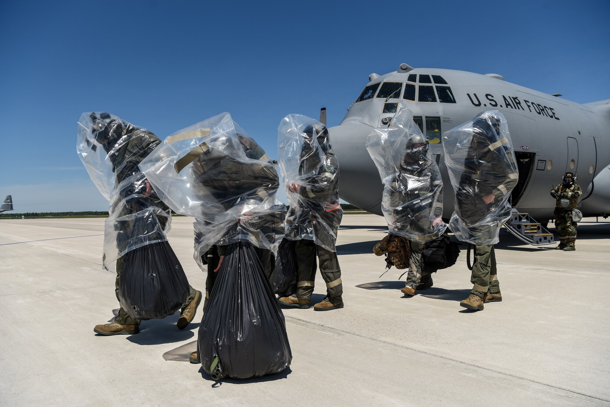 Aircrew members from the 123rd Airlift Wing simulate the evacuation of a C-130 Hercules aircraft in the event of a chemical contamination during an Operational Readiness Exercise at the Alpena Combat Readiness Training Center in Alpena, Mich., on June 23, 2019. The ORE demonstrated the wing’s ability to mobilize, fly to a remote site, operate in a hostile stateside environment and re-deploy back home while being evaluated. (U.S. Air National Guard photo by Staff Sgt. Joshua Horton)