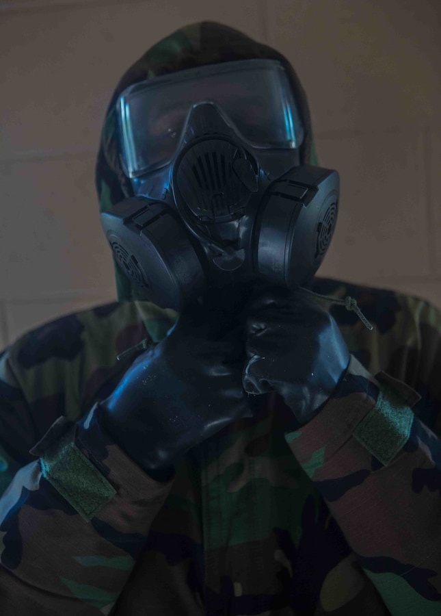 A U.S. Marine with Marine Wing Communications Squadron 48, Marine Air Control Group 48, 4th Marine Aircraft Wing, breaks the seal of his Mission Oriented Protective Posture jacket at Joliet Army Training Area, Elwood, Ill., July 15, 2019.  MWCS-48 is conducting exercises ranging from rifle and pistol qualifications to land navigation to meet annual training requirements, as well as increase occupational proficiency. (U.S. Marine Corps photo by Lance Cpl. Preston L. Morris)