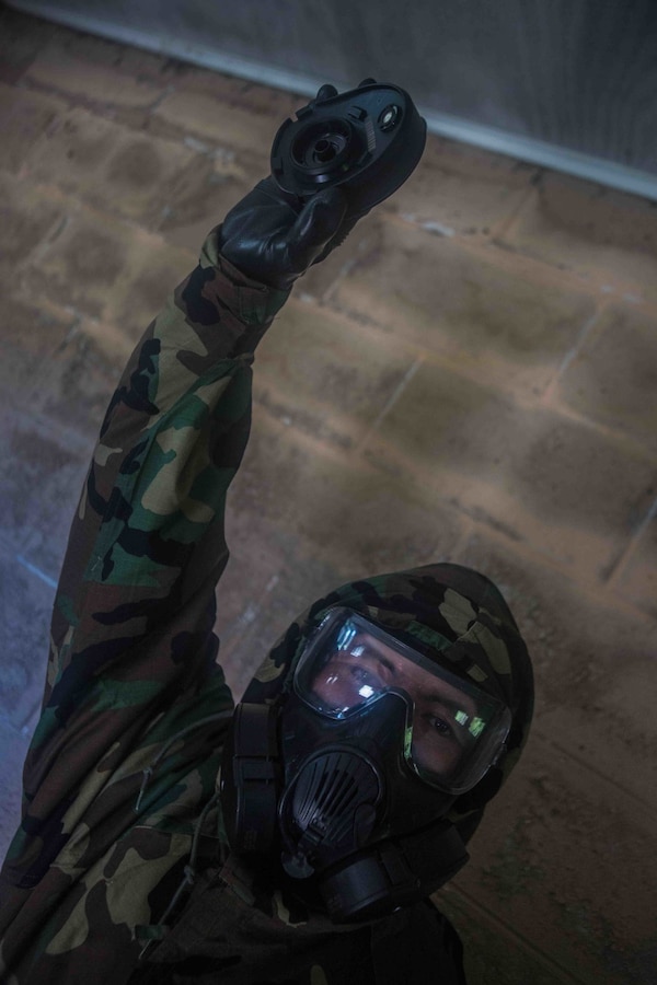 A U.S. Marine with Marine Wing Communications Squadron 48, Marine Air Control Group 48, 4th Marine Aircraft Wing, holds a gas mask filter at Joliet Army Training Area, Elwood, Ill., July 15, 2019. MWCS-48 is conducting exercises ranging from rifle and pistol qualifications to land navigation to meet annual training requirements, as well as increase occupational proficiency. (U.S. Marine Corps photo by Lance Cpl. Preston L. Morris)