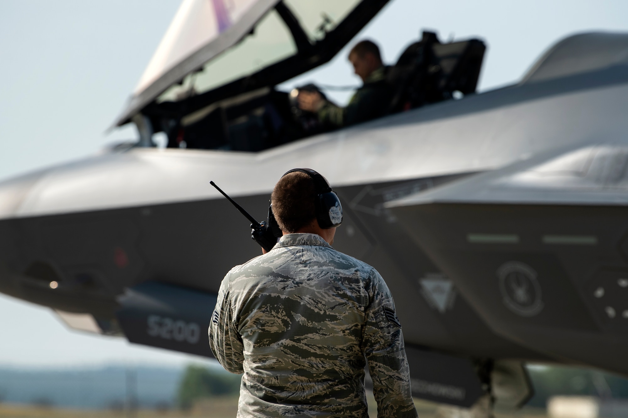 U.S. Air Force Capt. Joseph Walz, 421st Fighter Squadron F-35A Lightning II pilot, and Staff Sgt. David Sasak, 421st FS crew chief, conduct a pre-flight check during Operation Rapid Forge at Spangdahlem Air Base, Germany, July 18, 2019. Rapid Forge aircraft are forward deploying to train in coordination with NATO allies. Conducting exercises and operations with allied forces increases the U.S. Air Force's ability to quickly respond to potential threats. (U.S. Air Force photo by Airman 1st Class Valerie Seelye)