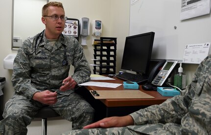 Capt. (Dr.) David Stachniak, 59th Medical Operations Squadron staff pediatrician, assesses a basic military trainee’s medical history during an appointment June 28 at Reid Clinic, Joint Base San Antonio-Lackland. Stachniak regularly does a rotation at the Reid Clinic to help trainees stay mission ready
