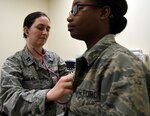 Capt. Natalie Aguilar, 59th Medical Operations Squadron pediatric nurse practitioner, checks a basic military trainee’s heart and lungs during an appointment June 28 at Reid Clinic, Joint Base San Antonio-Lackland. Aguilar volunteers a few days a week at the clinic and sees about 20 patients a day.