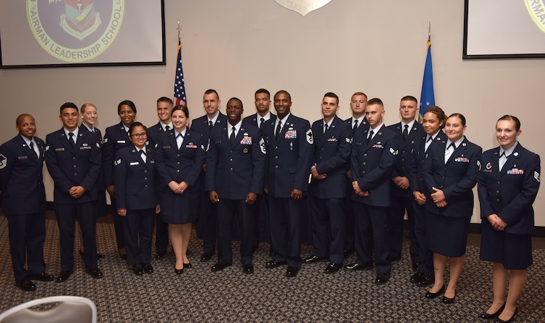 The Airman Leadership Class 19-E gather after their graduation ceremony for a group photo at the event center on Goodfellow Air Force Base, Texas, July 11, 2019. ALS is a six-week course designed to prepare senior airmen for supervisory duties by offering instruction in leadership, followership, written and oral communication skills, and the profession of arms. (U.S. Air Force photo by Senior Airman Seraiah Wolf/Released)