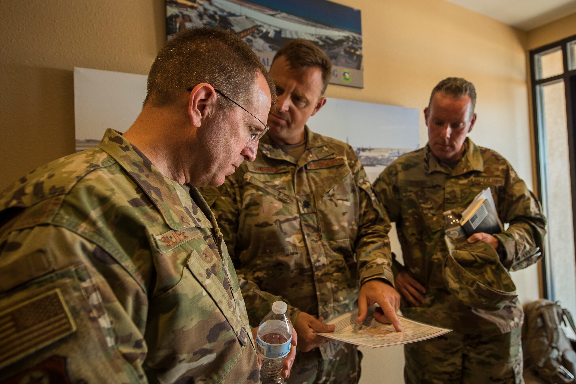 Lt. Gen. Jim Slife, Air Force Special Operations Command commander, and Chief Master Sgt. Cory Olson, AFSOC command chief, receive an initial briefing at Melrose Air Force Range from Lt. Col. Michael Janssen, 27th Special Operations Air Operations Squadron commander, at Cannon Air Force Base, N.M., July 15, 2019. During the tour, Slife saw how Cannon’s Air Commandos utilize MAFR for training. Slife visited the range’s air traffic control tower, command facility, and exercise locations. (U.S. Air Force photo by Senior Airman Vernon R. Walter III)
