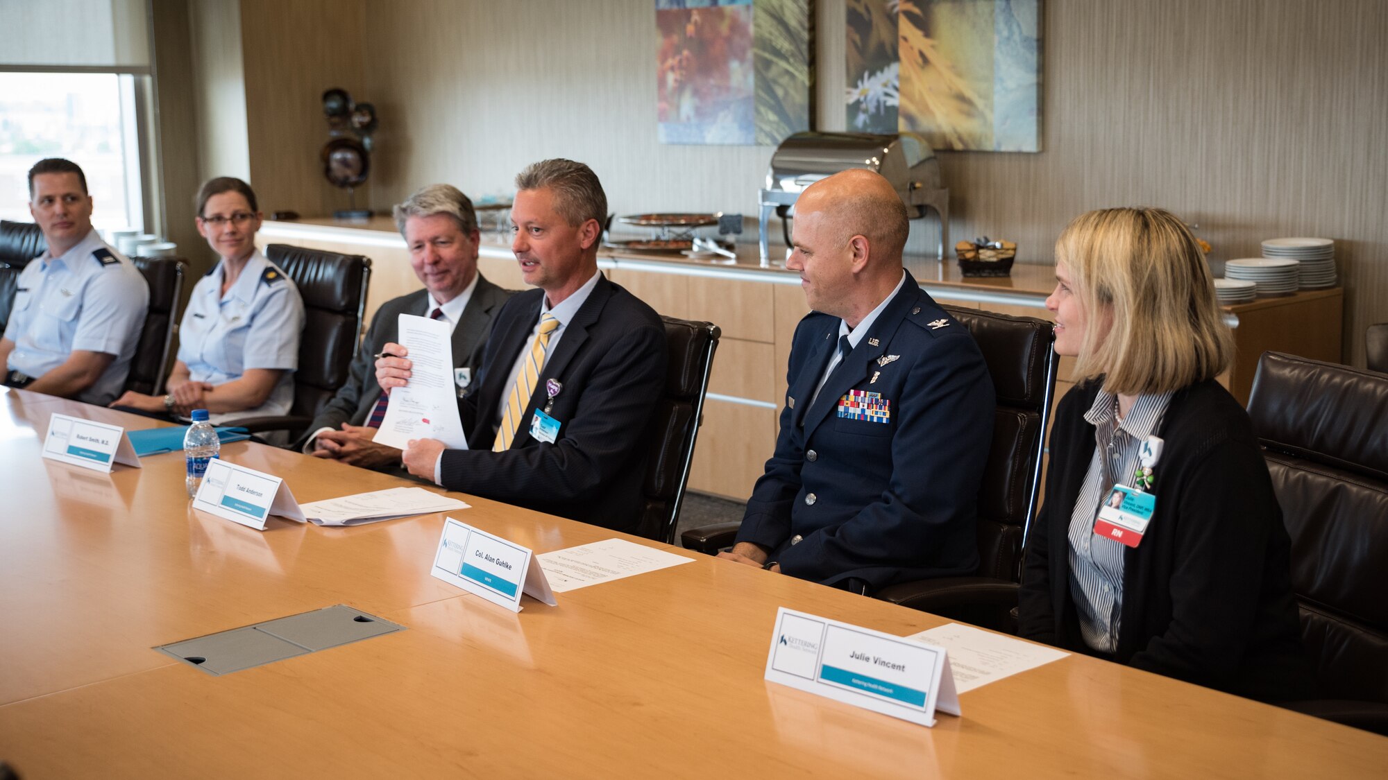 Todd Anderson, executive vice president for Kettering Health Network, holds up a training affiliation agreement he signed July 15 authorizing medical personnel from the 711th Human Performance Wing’s United States Air Force School of Aerospace Medicine to partner together with Kettering Health Network to enhance the readiness of Air Force medical service personnel. (U.S. Air Force photo/Richard Eldridge)