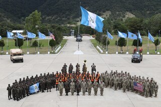 A large group of military personnel pose for a picture