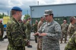 Royal Canadian Air Force Maj. Dwayne Demers, 8 Mission Support Squadron commander, left, and Pennsylvania Air National Guard Capt. Matthew Saccone speak during a cookout in Trenton, Ontario, Canada July 12, 2019.