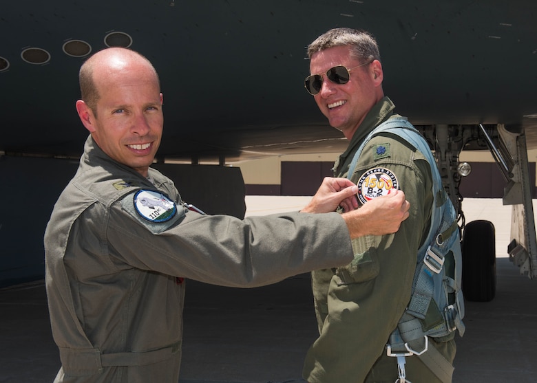 Col. Matthew Calhoun, the 131st Bomb Wing vice commander, presented Lt. Col. Timothy B. Rezac, commander of the 110th Bomb Squadron, with a commemorative patch on July 2, 2019, at Whiteman Air Force Base, Missouri. Rezac became the 14th ever B-2 Spirit pilot to reach 1500 flight hours in the stealth bomber. (U.S. Air Force photo by Senior Airman Ashley Adkins)