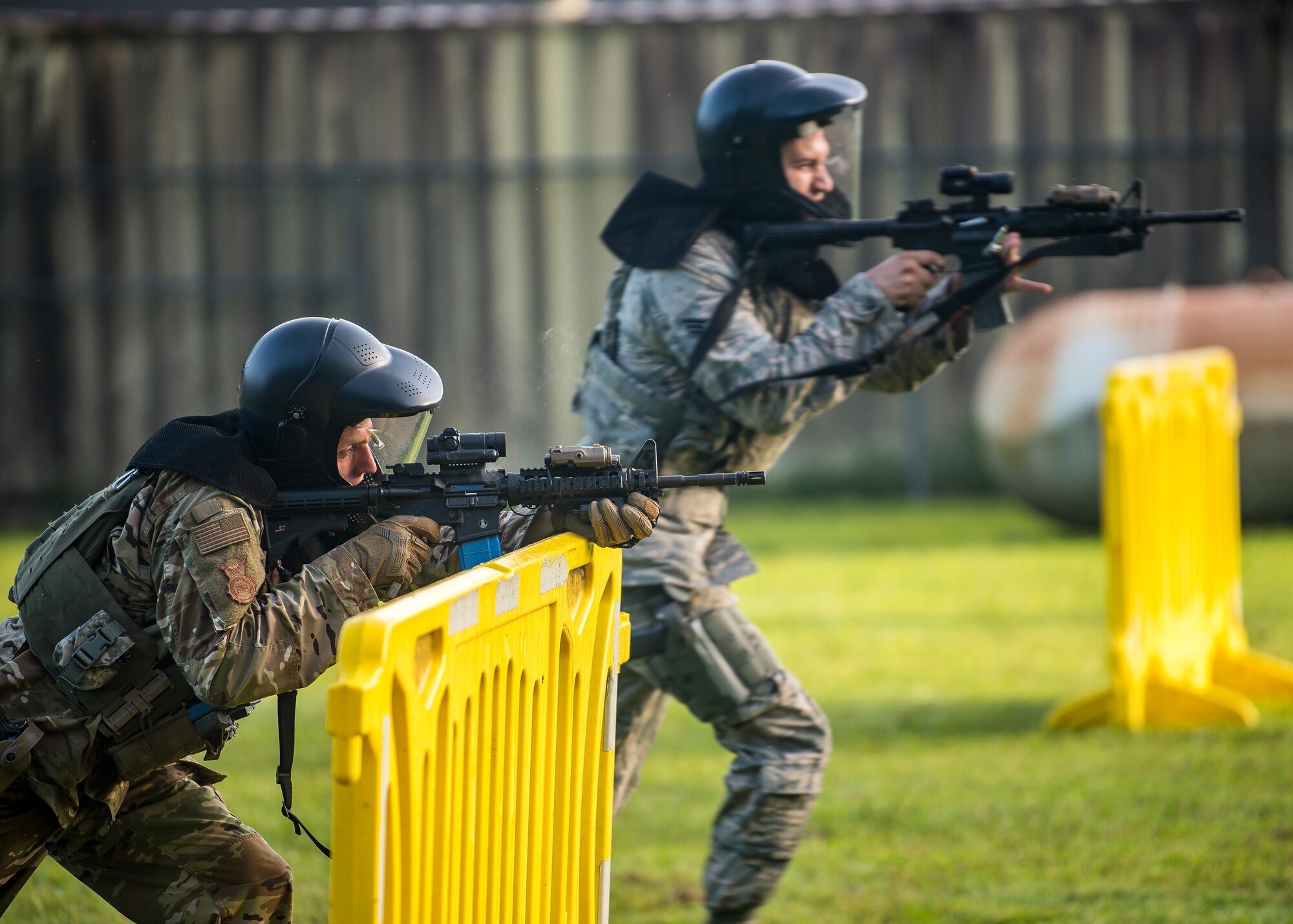 Staff Sgt. Christian Bertram, left, 23d Security Forces Squadron (SFS) patrolman, shoots cover fire for Senior Airman Kyle Macintyre, 23d SFS patrolman during a training exercise, July 15, 2019, at Moody Air Force Base, Ga. The “Shoot, move, communicate” training exercise put participants through practice maneuvers taking turns providing cover fire while others advanced on the enemy. Airmen learned how to shoot, move and communicate to build confidence in themselves, their wingmen and with their weapons. (U.S. Air Force photo by Airman 1st Class Eugene Oliver)