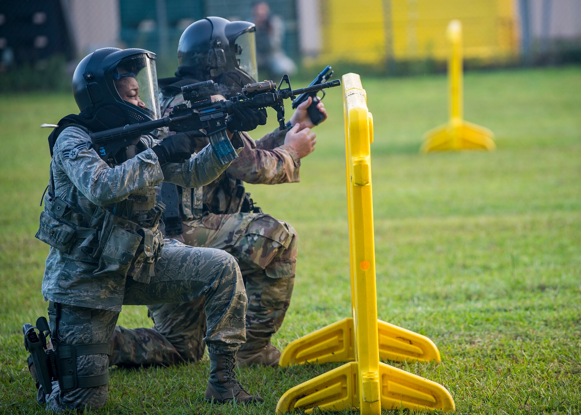 Airmen from the 23d Security Forces Squadron (SFS), defend their positions during a training exercise, July 15, 2019, at Moody Air Force Base, Ga. The “Shoot, move, communicate” training exercise put participants through practice maneuvers taking turns providing cover fire while others advanced on the enemy. Airmen learned how to shoot, move and communicate to build confidence in themselves, their wingmen and with their weapons. (U.S. Air Force photo by Airman 1st Class Eugene Oliver)