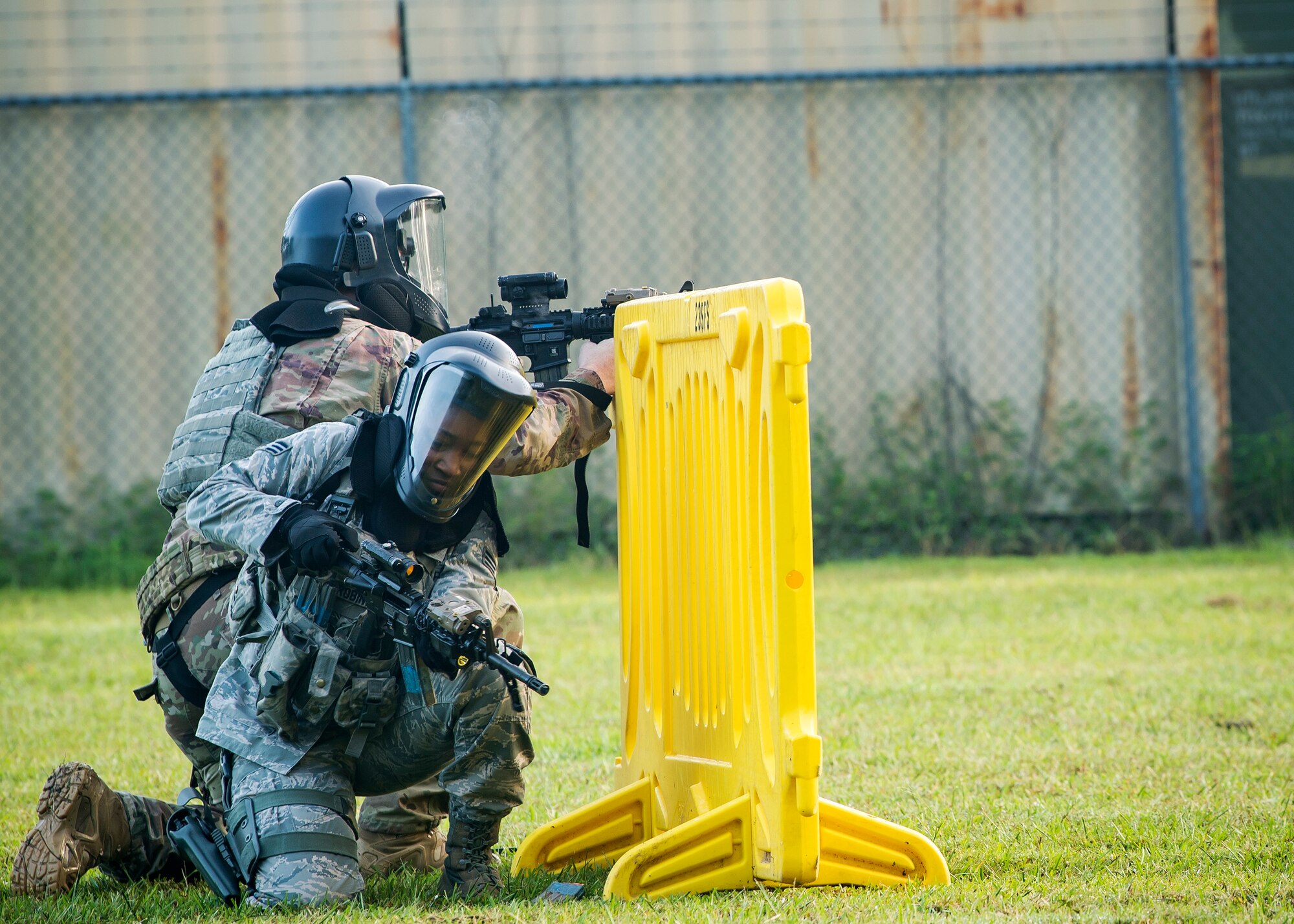 Senior Airman Micah McCall, back, 23d Security Forces Squadron (SFS) patrolman, shoots cover fire while Senior Airman Marcuria Robinson, 23d SFS patrolman, reloads an M4 carbine during a training exercise, July 15, 2019, at Moody Air Force Base, Ga. The “Shoot, move, communicate” training exercise put participants through practice maneuvers taking turns providing cover fire while others advanced on the enemy. Airmen learned how to shoot, move and communicate to build confidence in themselves, their wingmen and with their weapons. (U.S. Air Force photo by Airman 1st Class Eugene Oliver)