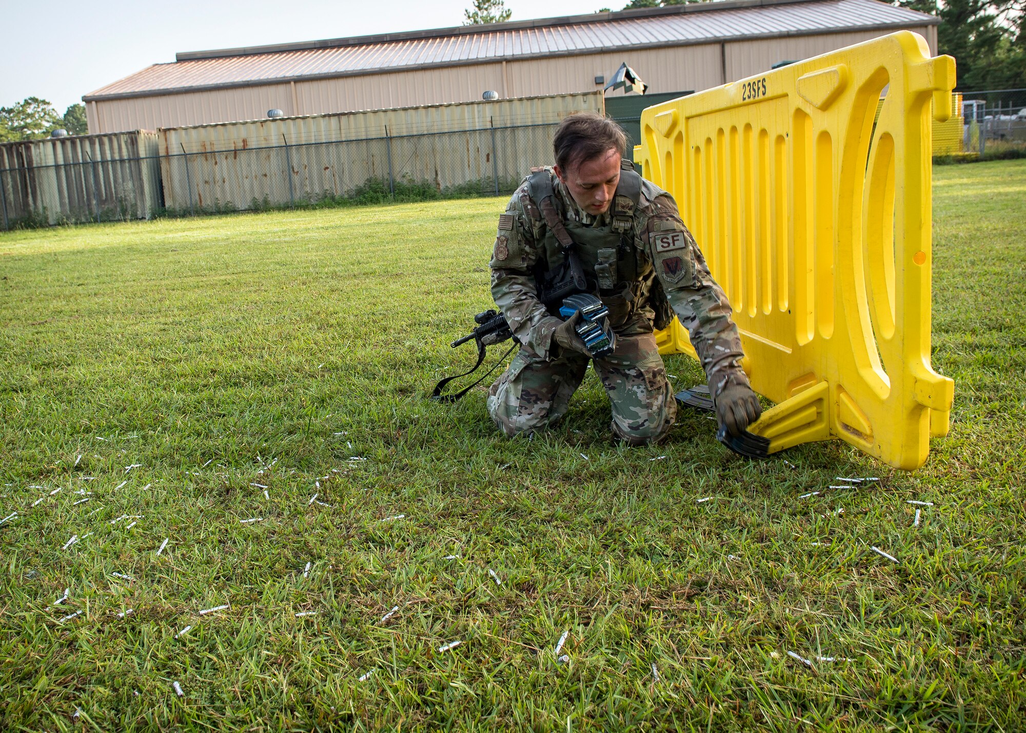 Staff Sgt. Christian Bertram, 23d Security Forces Squadron patrolman, picks up ammunition magazines and expended rounds following a training exercise, July 15, 2019, at Moody Air Force Base, Ga. The “Shoot, move, communicate” training exercise put participants through practice maneuvers taking turns providing cover fire while others advanced on the enemy. Airmen learned how to shoot, move and communicate to build confidence in themselves, their wingmen and with their weapons. (U.S. Air Force photo by Airman 1st Class Eugene Oliver)