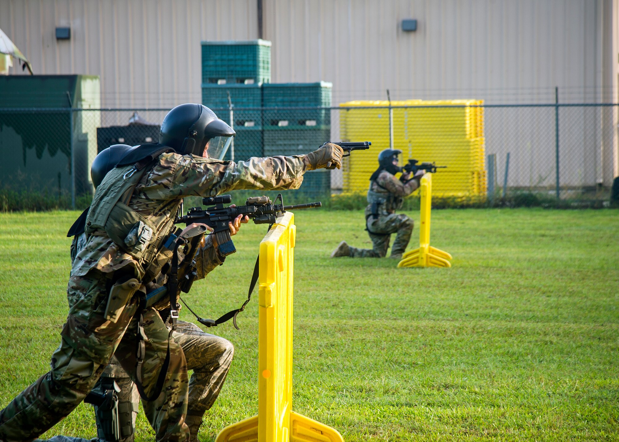 Airmen from the 23d Security Forces Squadron, defend their positions during a training exercise, July 15, 2019, at Moody Air Force Base, Ga. The “Shoot, move, communicate” training exercise put participants through practice maneuvers taking turns providing cover fire while others advanced on the enemy. Airmen learned how to shoot, move and communicate to build confidence in themselves, their wingmen and with their weapons. (U.S. Air Force photo by Airman Azaria E. Foster)