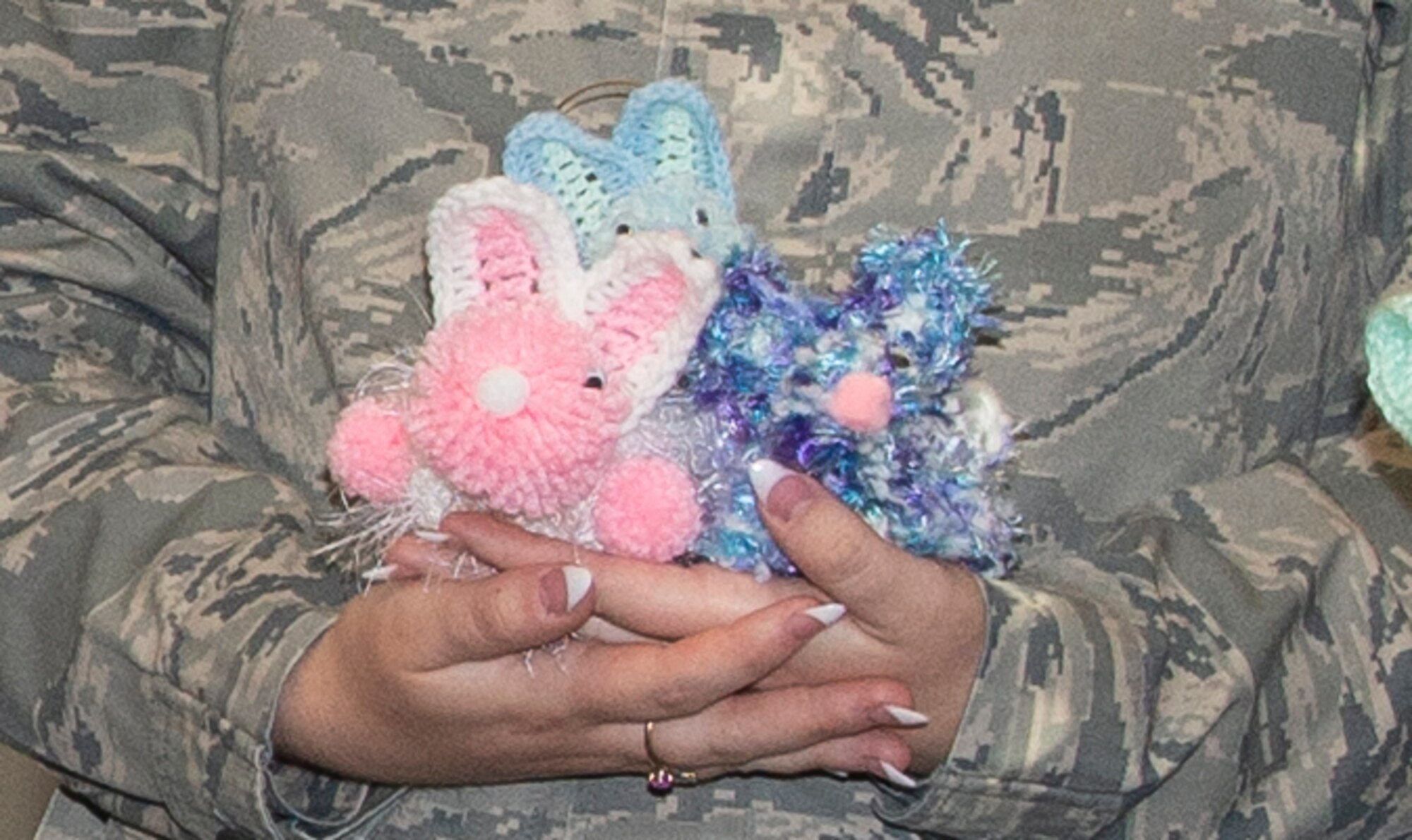 Hand crocheted bunnies, held by Airman 1st Class Julie Hubble, 55th Comptroller Squadron, financial services technician, July 1, 2019, at Offutt Air Force Base, Nebraska. Hubble’s grandmother, Sally Harder, enjoys crafting items for military family members and friends. Harder has been sending crafts to military family members for decades, crafting over 100 per year.