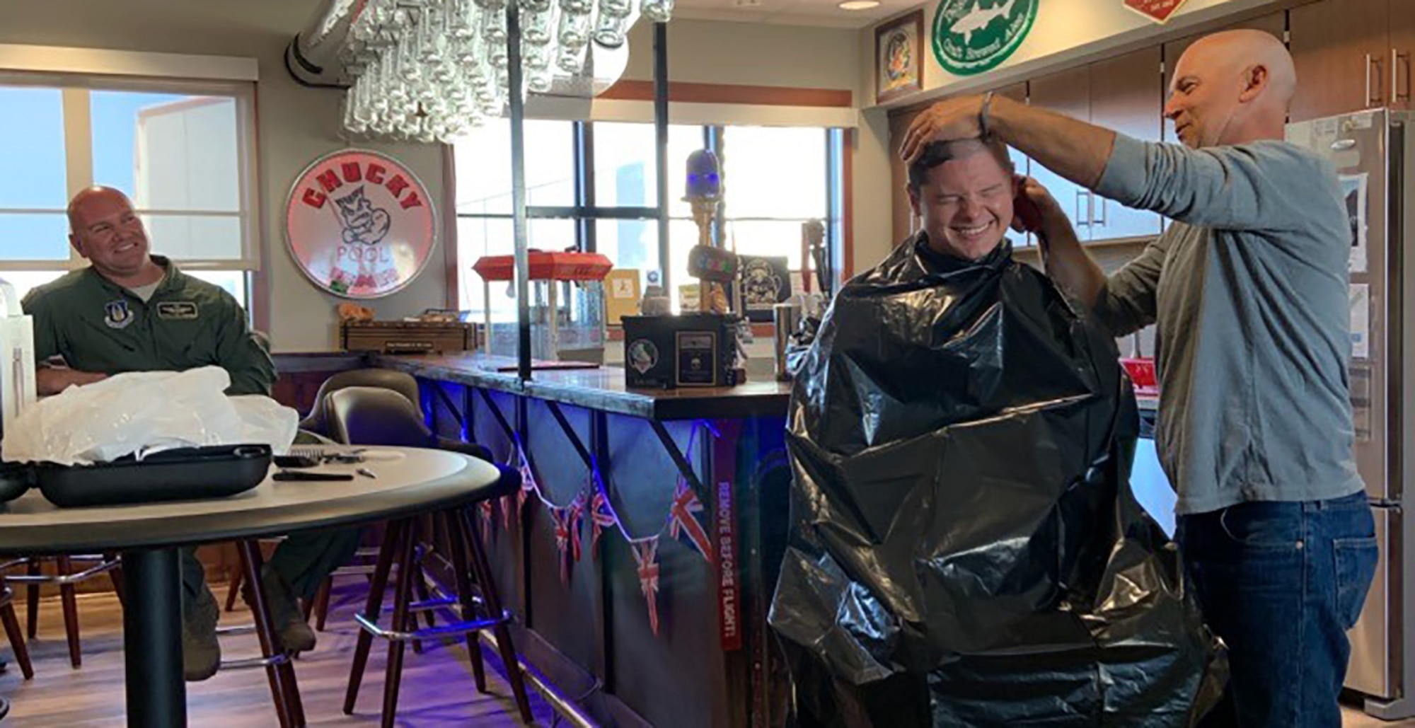 Without hesitation, 312th Airlift Squadron teammates transformed their heritage room into a makeshift barbershop and administered basic training style shearing in support of Master Sgt. Steve Hatfield.
