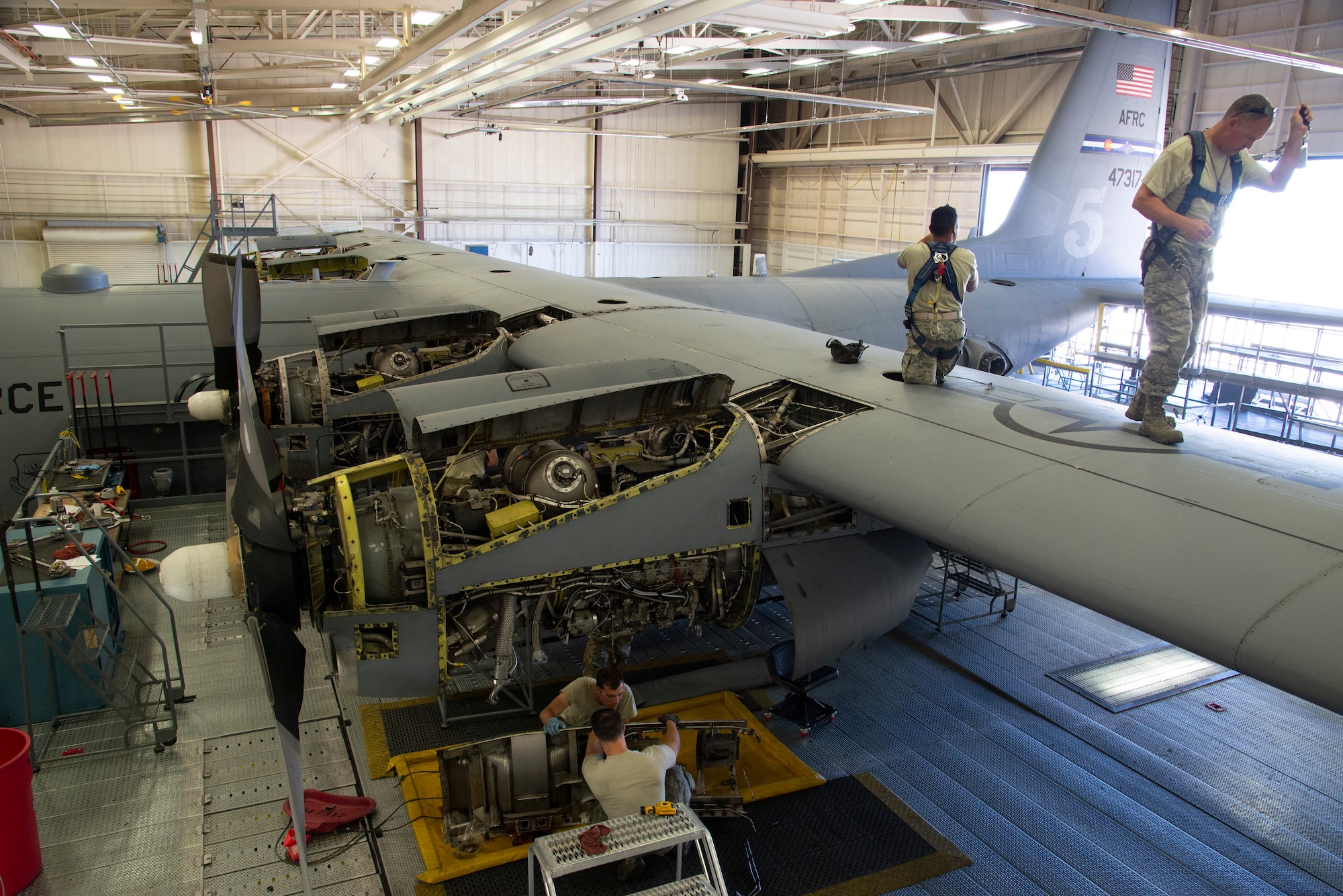 Reserve Citizen Airmen with the 302nd Maintenance Group examine a C-130 Hercules aircraft during an isochronal inspection at Peterson Air Force Base, Colorado, July 8, 2019.