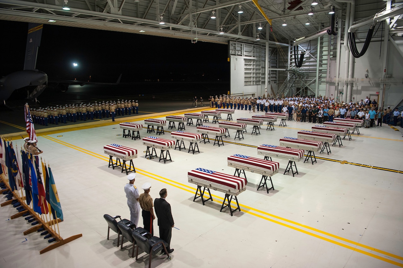 Service members stand during a repatriation ceremony.