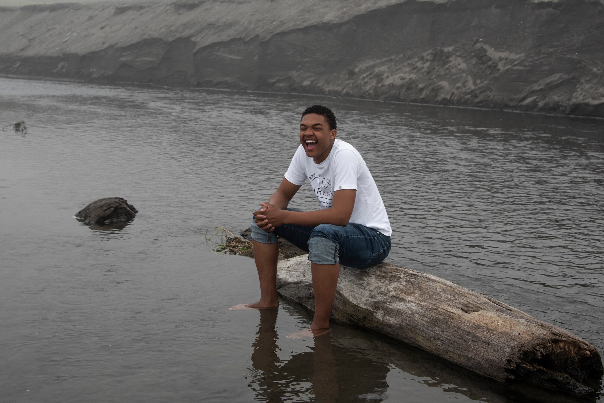 U.S. Air Force Airman Austin T. Clay, a 35th Maintenance Squadron weapons journeyman, sits on a log at Sabishiro Beach in Misawa, Japan, July 16, 2019. Clay hails from Tupelo, Mississippi; his favorite hobbies include singing, writing and exploring Japan. (U.S. Air Force photo by Airman 1st Class China M. Shock)