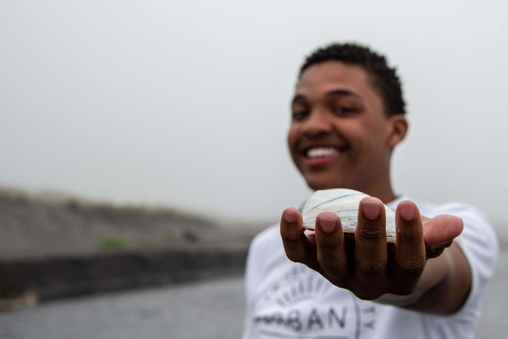 U.S. Air Force Airman Austin T. Clay, a 35th Maintenance Squadron weapons journeyman, holds a shell at Sabishiro Beach in Misawa, Japan, July 16, 2019. Clay often goes to the beach to reminisce, relax and think about all of his blessings. (U.S. Air Force photo by Airman 1st Class China M. Shock)