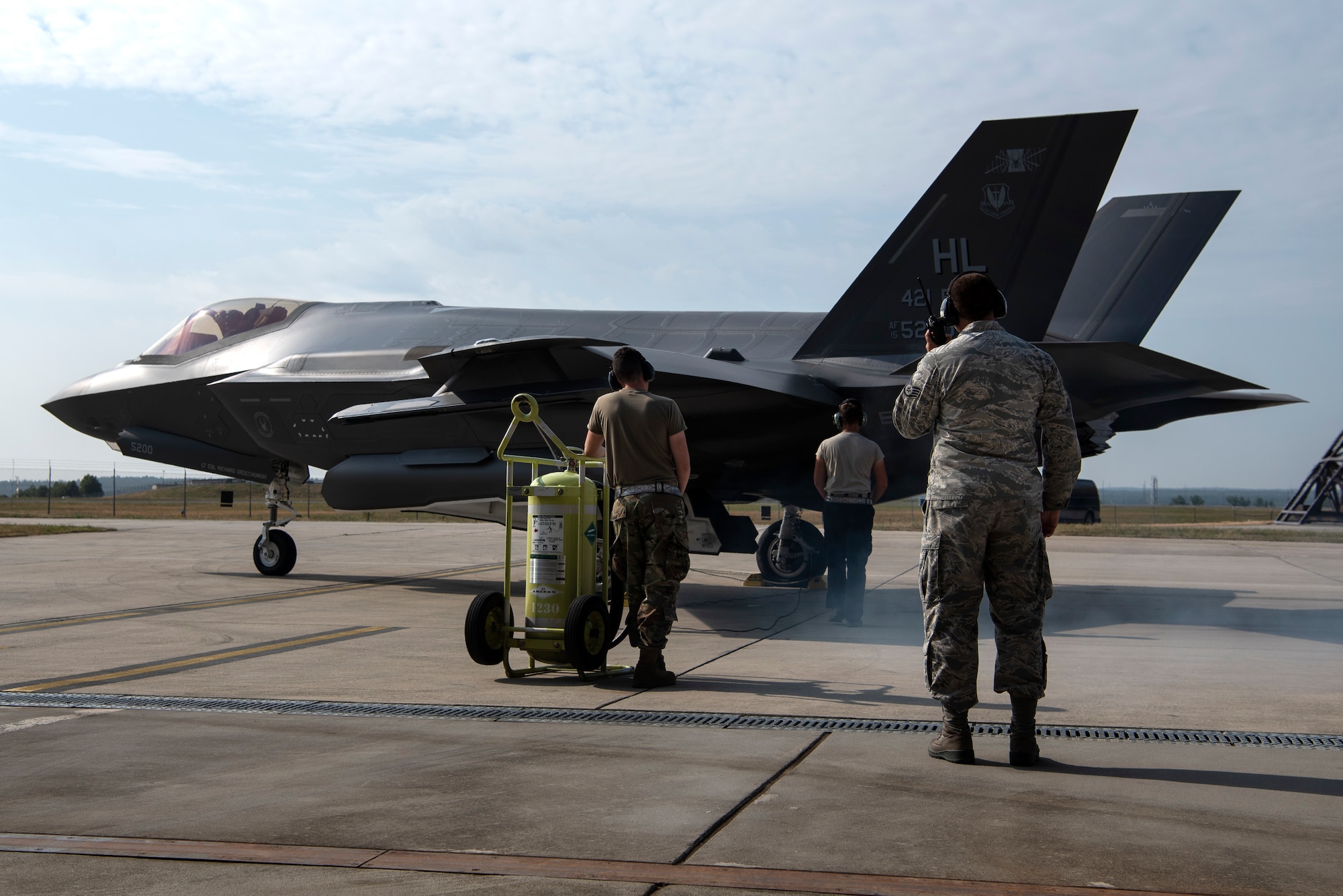 U.S. Air Force Senior Airman Tyler McGaughey, 421st Fighter Squadron avionics specialist, Airman 1st Class Cody Albert, 421st FS crew chief, and Staff Sgt. David Sasak, 421st FS crew chief, prepare an F-35A Lightning II for launch during Operation Rapid Forge at Spangdahlem Air Base, Germany, July 18, 2019. Rapid Forge aircraft are forward deploying to bases in the territory of NATO allies. Training with multinational air forces during operations strengthens allied coalition forces. (U.S. Air Force photo by Airman 1st Class Valerie Seelye)