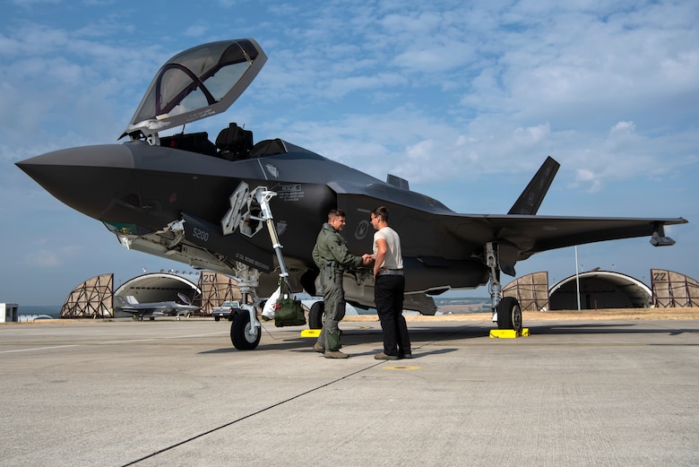 U.S. Air Force Capt. Joseph Walz, 421st Fighter Squadron F-35A Lightning II pilot, shakes hands with Airman 1st Class Cody Albert, 421st FS crew chief, during Operation Rapid Forge at Spangdahlem Air Base, Germany, July 18, 2019. Rapid Forge aircraft are forward deploying to the territory of NATO allies in order to enhance readiness and improve interoperability. Participation in multinational operations enhances the U.S. Air Force's relationship with partner militaries. (U.S. Air Force photo by Airman 1st Class Valerie Seelye)