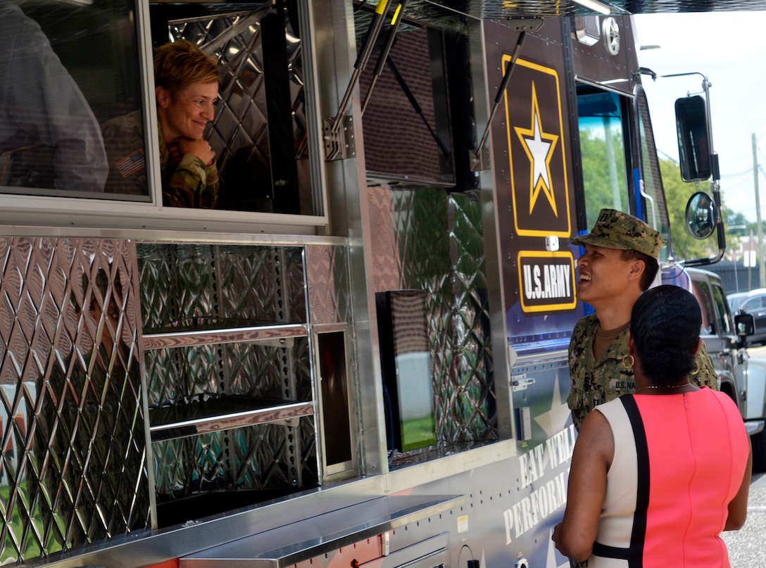 A new food truck purchased by the Defense Logistics Agency Troop Support for the Army's Joint Center of Culinary Excellence stopped at the DLA headquarters in Philadelphia on July 9, 2019. Richard Ellis, left, the deputy commander of Defense Logistics Agency Troop Support, gets a tour of the new Army food truck from Dean Schoendorfer, right, the integrated support team chief within the Subsistence supply chain’s Food Equipment branch at DLA Troop Support.