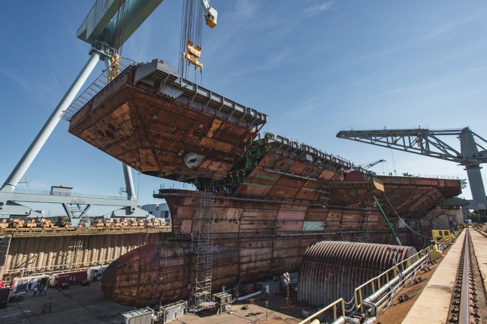 The final piece of the flight deck of the future USS John F. Kennedy (CVN 79) is lifted into place at Huntington Ingalls Industries' Newport News Shipbuilding Division in Newport News, Va., July 10.