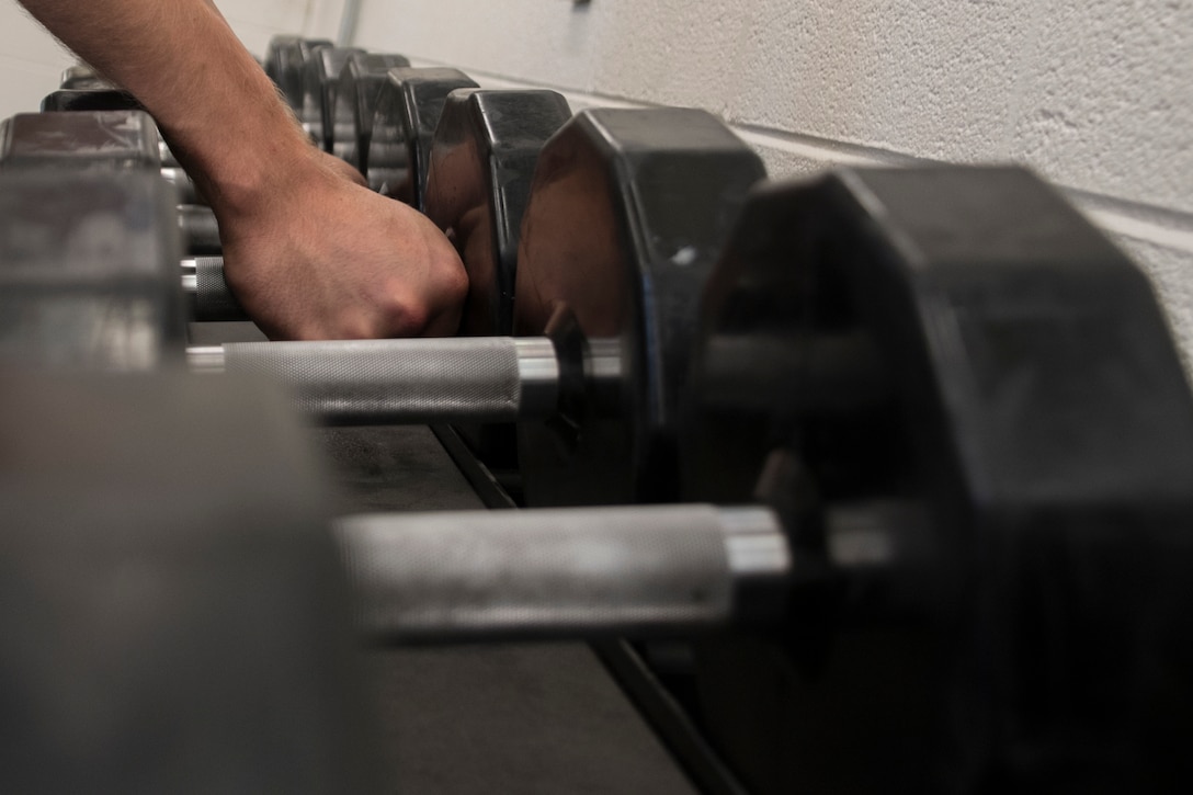 Staff Sgt. Steven Naughton, an Operations Intelligence Analyst at the 179th Airlift Wing, Mansfield, Ohio, exercises in the base gym June 8, 2019. Fitness is recognized as one of the four pillars of Comprehensive Airman Fitness, a concept used in the Air Force to ensure Airmen always remain ready to accomplish the mission. (U.S. Air National Guard photo by Senior Airman Megan Shepherd)