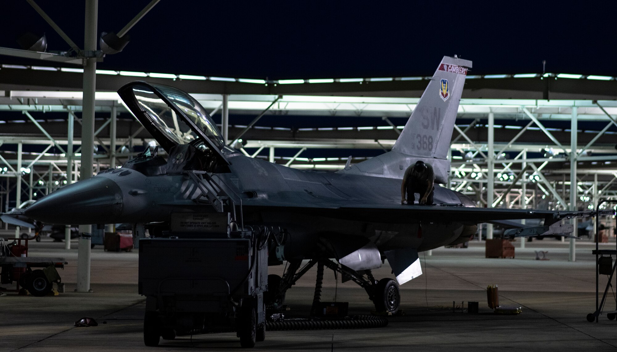 A U.S. Air Force tactical aircraft maintainer assigned to the 20th Aircraft Maintenance Squadron performs maintenance on the wing of an F-16CM Viper at Shaw Air Force Base, South Carolina, July 12, 2019.