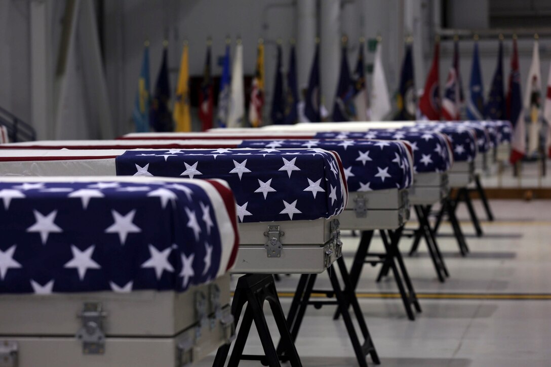 Transfer cases containing the possible remains of fallen service members rest in in a hangar during an honorable carry for the possible remains of unidentified service members lost in the Battle of Tarawa during World War II conducted by the Defense POW/MIA Accounting Agency and U.S. Marine Corps Forces, Pacific, at Joint Base Pearl Harbor-Hickam, Hawaii, July 17, 2019. The possible remains were recently recovered from the Republic of Kiribati by History Flight, a DPAA partner organization, and will be accessioned into DPAA's laboratory facility in Hawaii to begin the identification process in support of DPAA's mission to provide the fullest possible accounting for our missing personnel to their families and the nation.