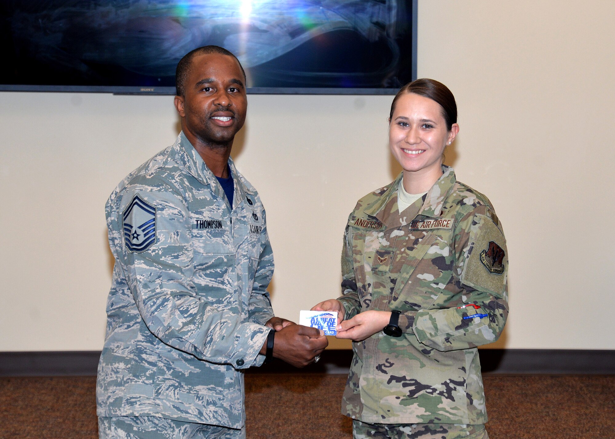Senior Master Sgt. Anthony Thompson Jr., 55th Force Support Squadron career assistance advisor, presents Airman 1st Class Debra Anderson, 55th Wing Judge Advocate paralegal, with a gift as the winner of the 55th FSS Amazing Offutt Scavenger Hunt at Offutt Air Force Base, Neb., July 12, 2019. Students of the First Term Airmen’s Center course, which is an introductory course for new Airmen when they arrive at their first duty station, participate in the scavenger hunt as an interactive way toget acquainted with base services.