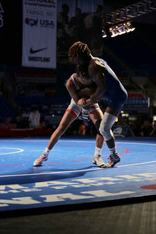 Anthony Molton from Team Illinois wrestles and wins against Jakason Burks from Team Nebraska during the US Marine Corps Cadet and Junior National Championships in Fargo, North Dakota, July 16, 2019. USA Wrestling is the national governing body for the sport of wrestling and is the central organization that coordinates amateur wrestling programs in the nation and works to create interest and participation in these programs. The Marine Corps began partnering with USAW in 2017 to become intimately involved with the sport of wrestling through event activations, event branding and brand exposure through media. By partnering specifically with USAW, the Marine Corps reaches a broad cross-section of high school and collegiate-aged wrestlers as well as an ever-growing influencer network of coaches, referees, wrestling alumni and parents.