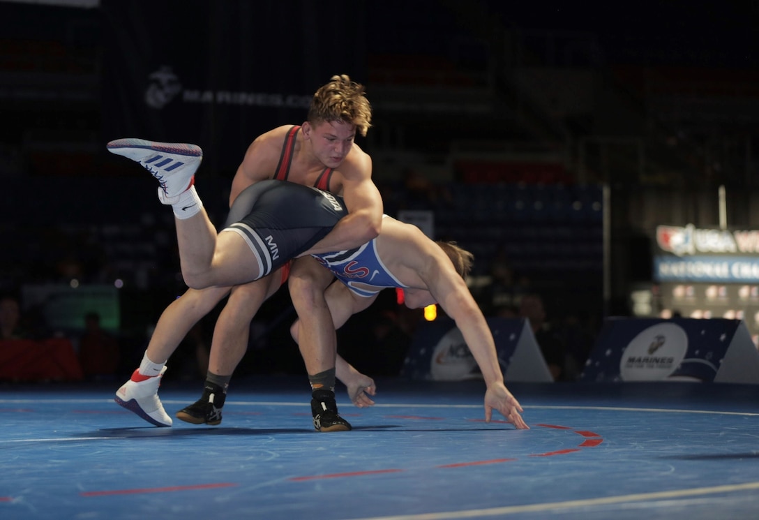 Gavin Nelson from Team Minnesota wrestles and wins against Tate Picklo from Team Oklahoma during the US Marine Corps Cadet and Junior National Championships in Fargo, North Dakota, July 18, 2019. USA Wrestling is the national governing body for the sport of wrestling and is the central organization that coordinates amateur wrestling programs in the nation and works to create interest and participation in these programs. The Marine Corps began partnering with USAW in 2017 to become intimately involved with the sport of wrestling through event activations, event branding and brand exposure through media. By partnering specifically with USAW, the Marine Corps reaches a broad cross-section of high school and collegiate-aged wrestlers as well as an ever-growing influencer network of coaches, referees, wrestling alumni and parents.