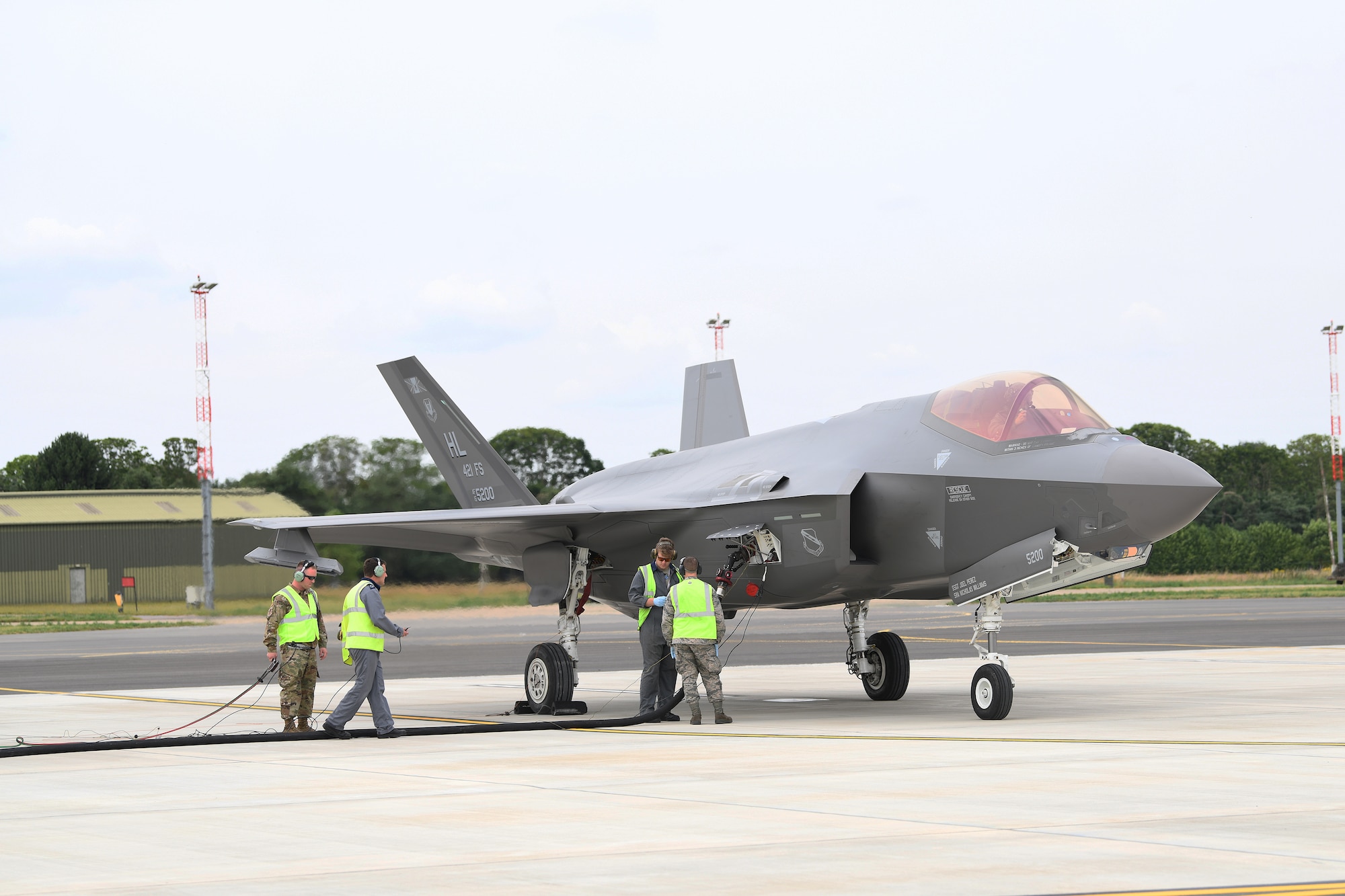 F-35A Lightning II aircraft conduct hot pit refueling at RAF Marham, England.