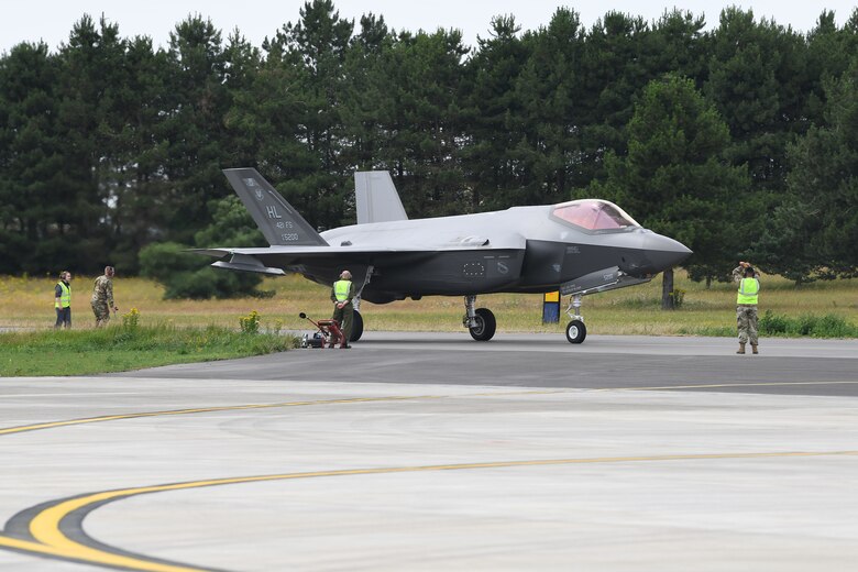F-35A Lightning II aircraft conduct hot pit refueling at RAF Marham, England.