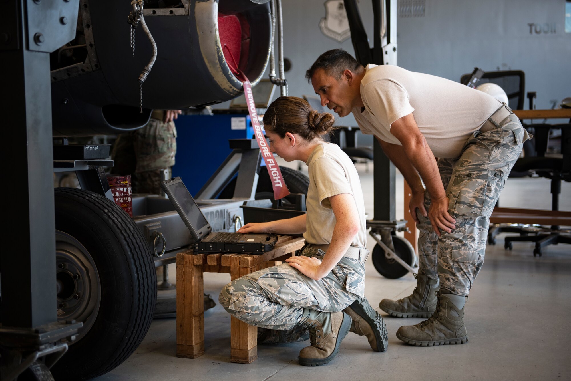 Airman 1st Class Rylee Johnson, left, and Senior Airman Enrique Yanez, 361st Training Squadron aerospace propulsion apprentice course students, look at their training objectives at Sheppard Air Force Base, Texas, July 18, 2019. Johnson and Yanez's objective for this day is to remove and re-install a T-56 turboprop engine's reduction gearbox, which helps the engine reduce the RPM to accommodate a propeller. (U.S. Air Force photo by Airman 1st Class Pedro Tenorio)