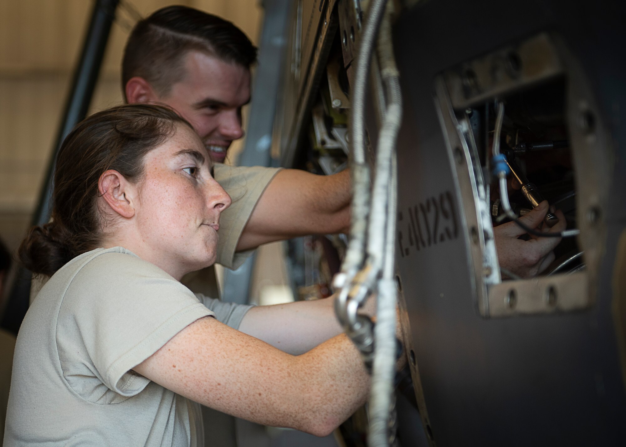 Airman 1st Class Rylee Johnson, front, and Airman 1st Class Jeremy Barnes, 361st Training Squadron aerospace apprentice course students, work on a T-56 turboprop engine at Sheppard Air Force Base, Texas, July 18, 2019. Barnes and Johnson are removing and re-installing a reduction gearbox. The gearbox reduces the engines RPM from 13820 to 1020, as the engine is a jet engine modified to have a propeller attached. (U.S. Air Force photo by Airman 1st Class Pedro Tenorio)