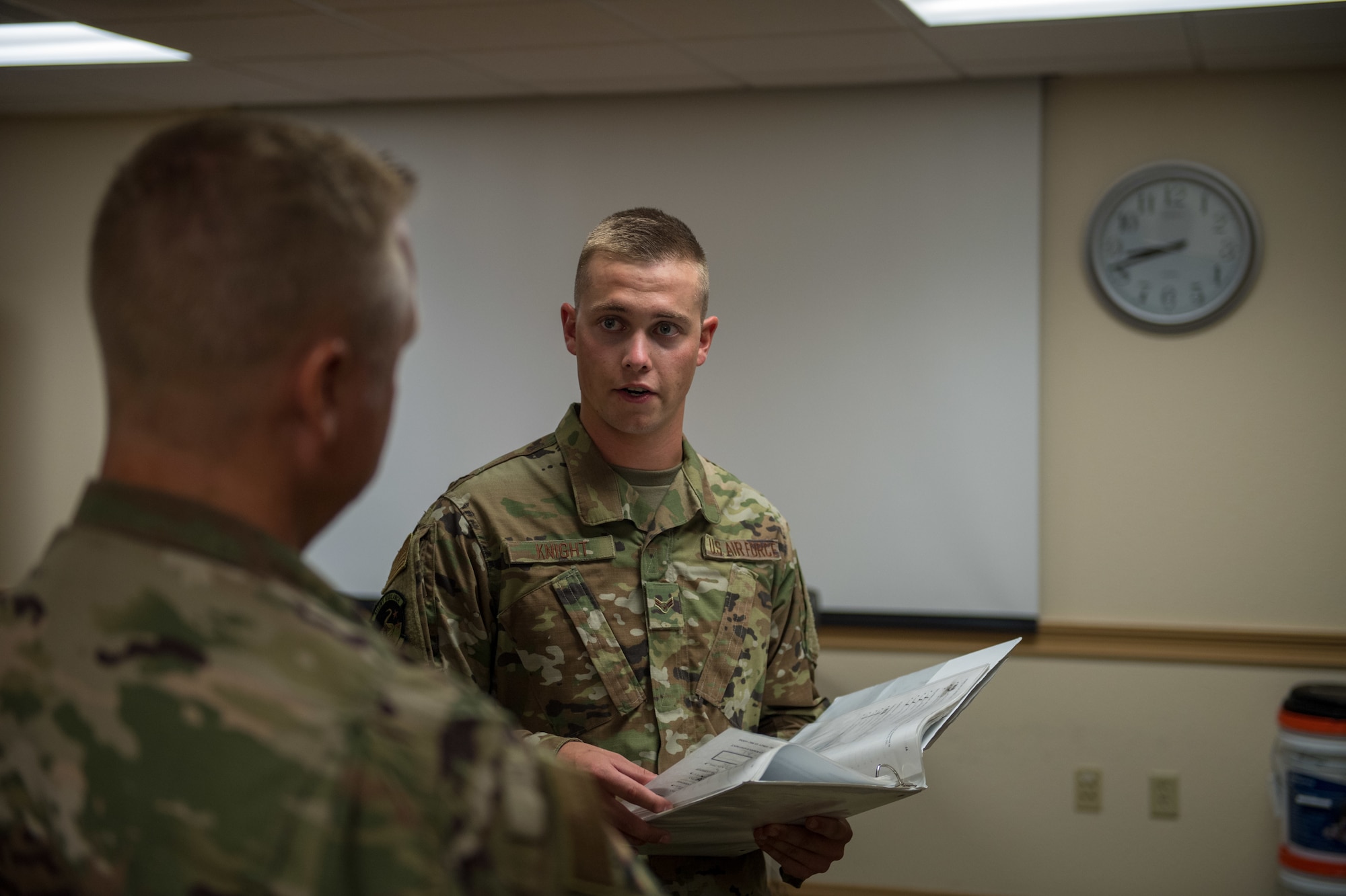 (Right) U.S. Air Force Airman 1st Class Thomas Knight, 325th Maintenance Squadron stockpile surveillance crew chief, gives Col. Brian Laidlaw, 325th Fighter Wing commander, a safety briefing at Tyndall Air Force Base, Florida, July 17, 2019.