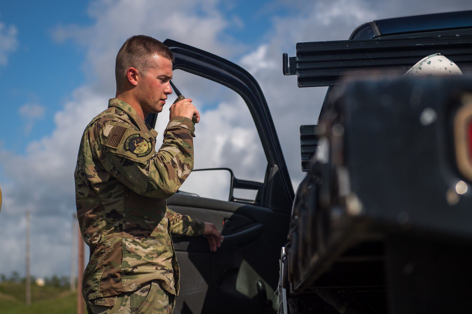 U.S. Air Force Airman 1st Class Thomas Knight, 325th Maintenance Squadron stockpile surveillance crew chief, talks into the walkie-talkie at Tyndall Air Force Base, Florida, July 17, 2019.