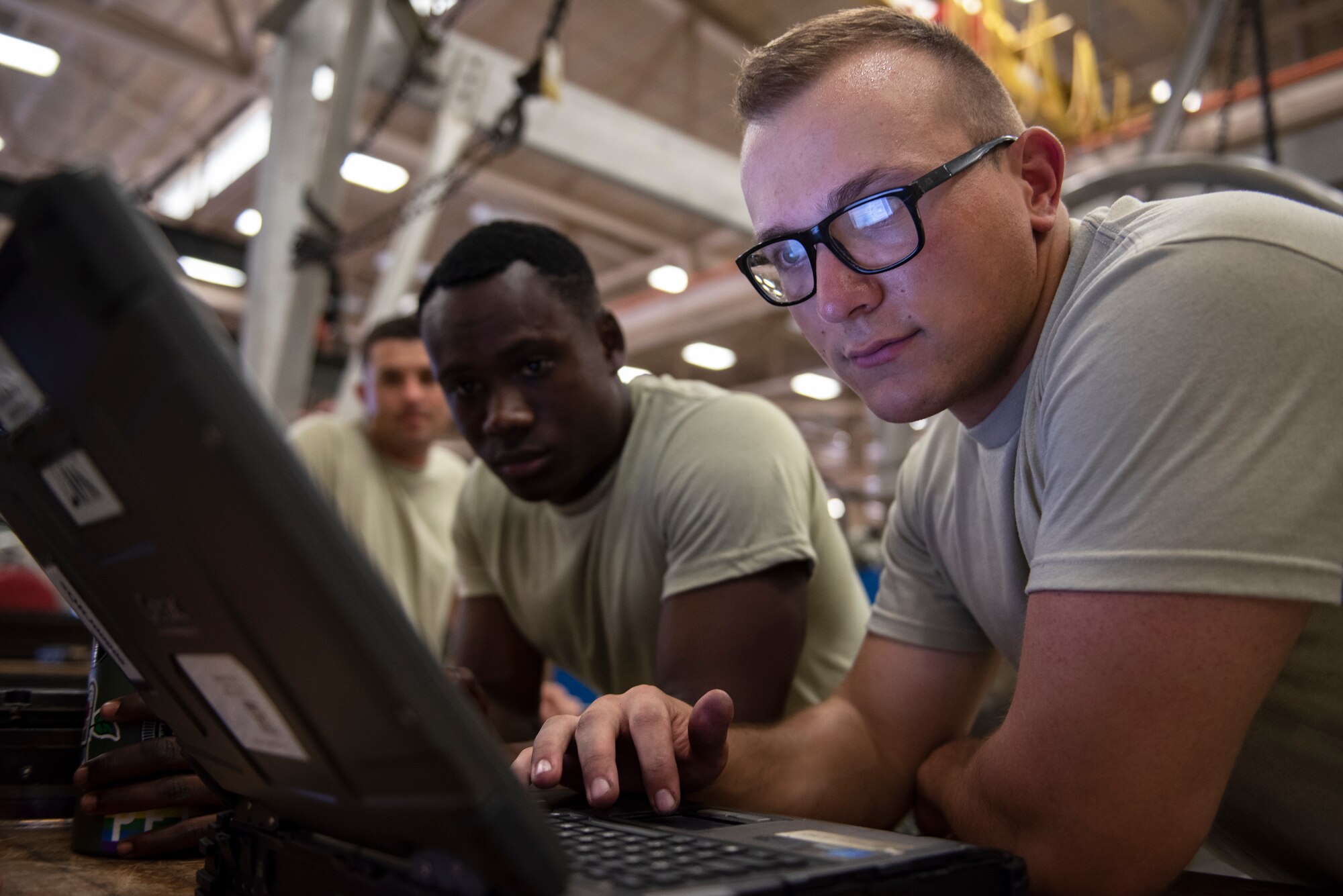 From right, Airman Michael Chepel, Airman 1st Class Ethan Gray and Airman 1st Class Matthew Stewart, 361st Training Squadron apprentice course students, look at their training objectives at Sheppard Air Force Base, Texas, July 18, 2019. Sheppard AFB is one of the largest training bases the Air Force has, and with so many Airmen going in and out it allows Americans from all around the states to work together for one mission and build comradery. You could see that in the picture as Chepel is from Graham, Washington, Gray is from Atlanta, Georgia, and Stewart is from Mansfield, Texas. (U.S. Air Force photo by Airman 1st Class Pedro Tenorio)