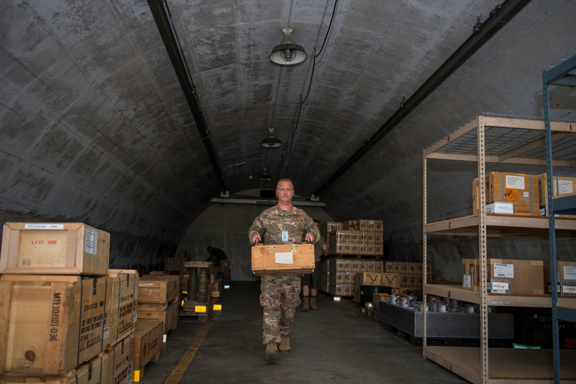 U.S. Air Force Col. Brian Laidlaw, 325th Fighter Wing commander, carries a box of munitions at Tyndall Air Force Base, Florida, July 17, 2019.