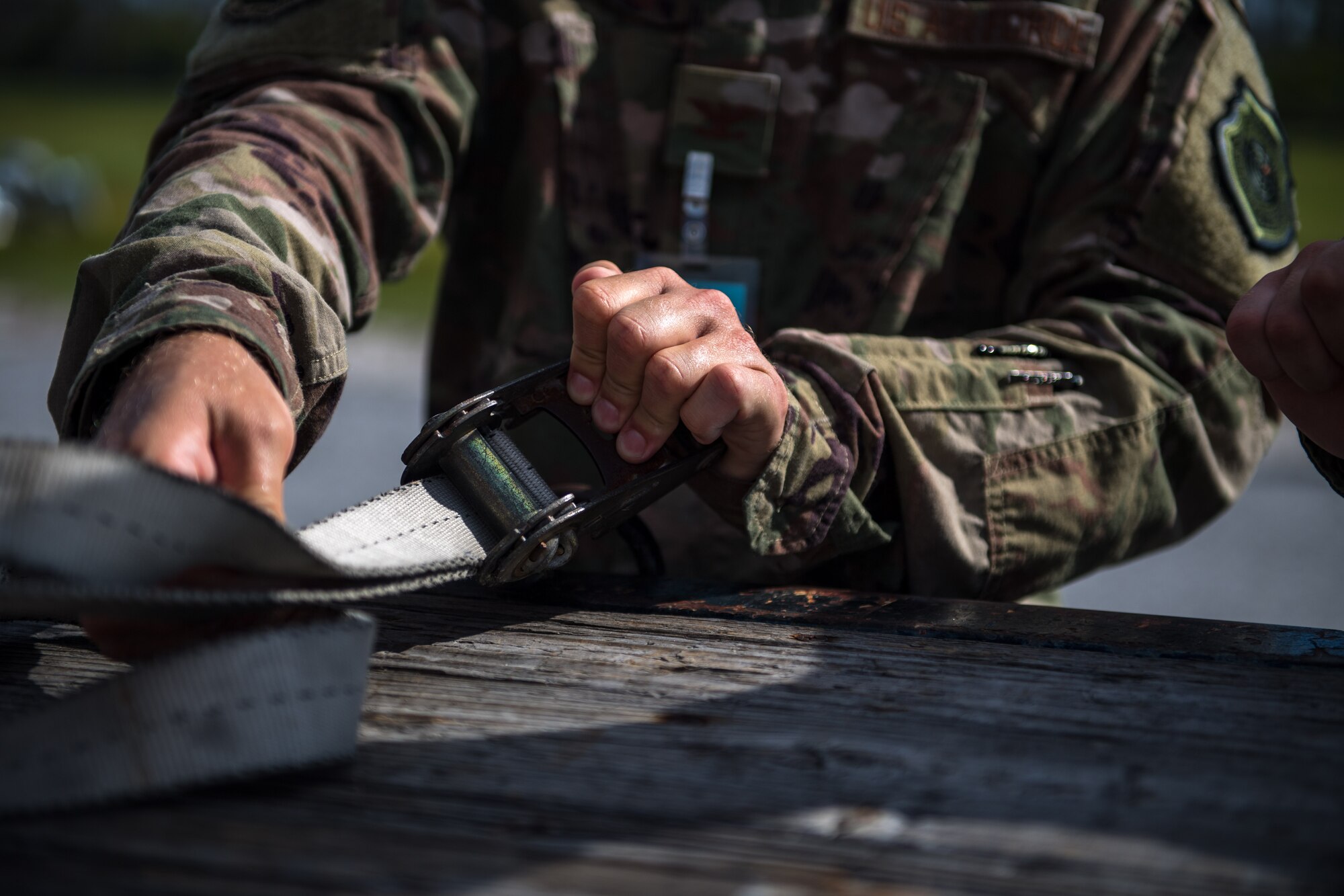 U.S. Air Force Col. Brian Laidlaw, 325th Fighter Wing commander, straps a box of munitions to a flatbed at Tyndall Air Force Base, Florida, July 17, 2019.