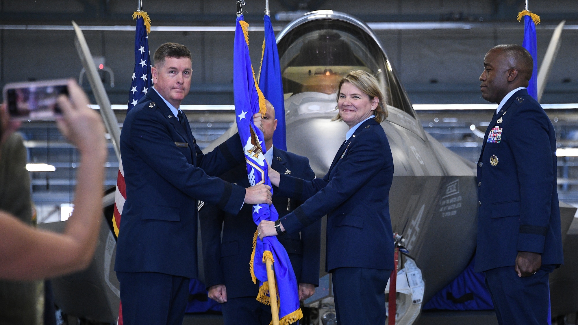 Lt. Gen. Donald Kirkland, Air Force Sustainment Center commander, passes the guidon to Brig. Gen. C. McCauley von Hoffman, incoming Ogden Air Logistics Complex commander, during a change of command ceremony July 19, 2019, at Hill Air Force Base, Utah.
